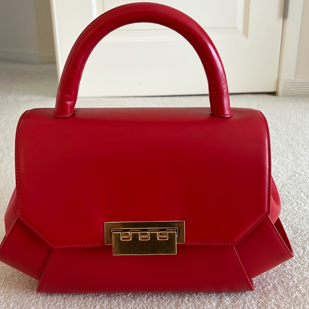 A red Zac Posen purse. Dimensions 13-9-6. Was used twice